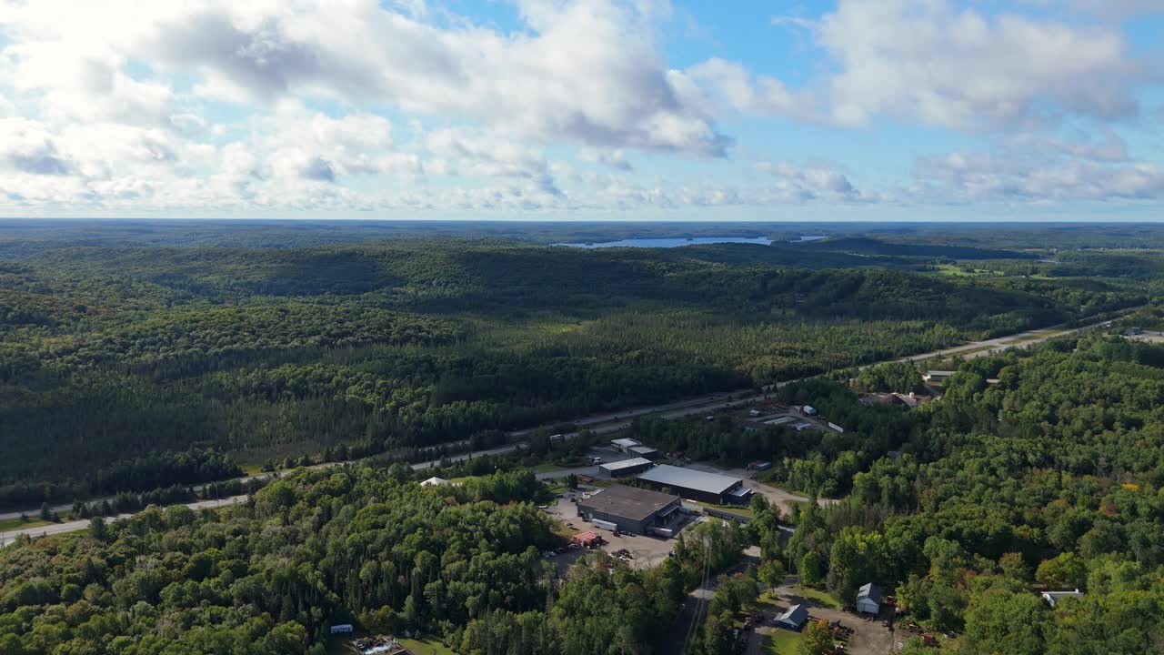 Industrial Business Next To Highway 11 Is Surrounded By Pristine Forest At Huntsville, Muskoka. Aerial Flyover