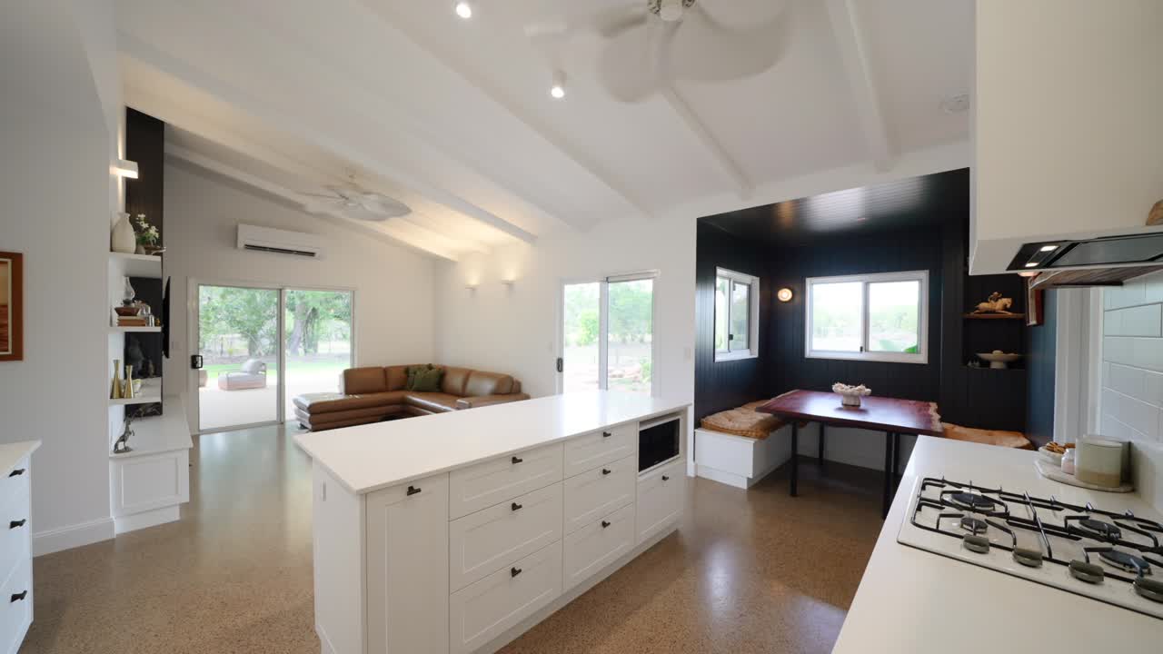 Barn style home interior with rustic wood beams, open layout, and cozy decor, blending modern and rural