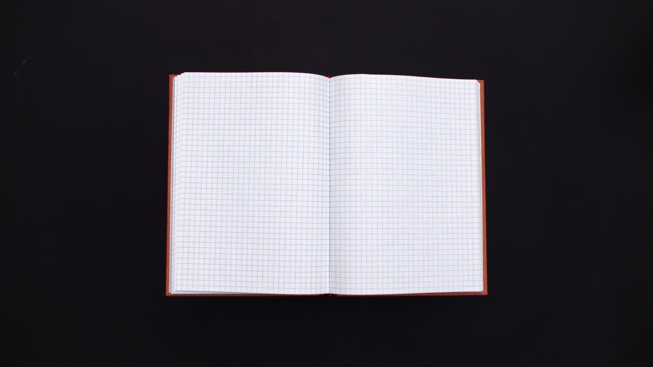 School supplies and open notebook on the blackboard