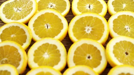 Halved-sweet-limes-arranged-on-wooden-plank