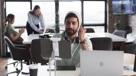 Young-Asian-business-man-in-green-shirt-is-on-a-video-call-in-an-office-setting