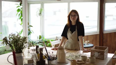 Red-haired-potter-girl-in-glasses-looks-straight-ahead-and-smiles