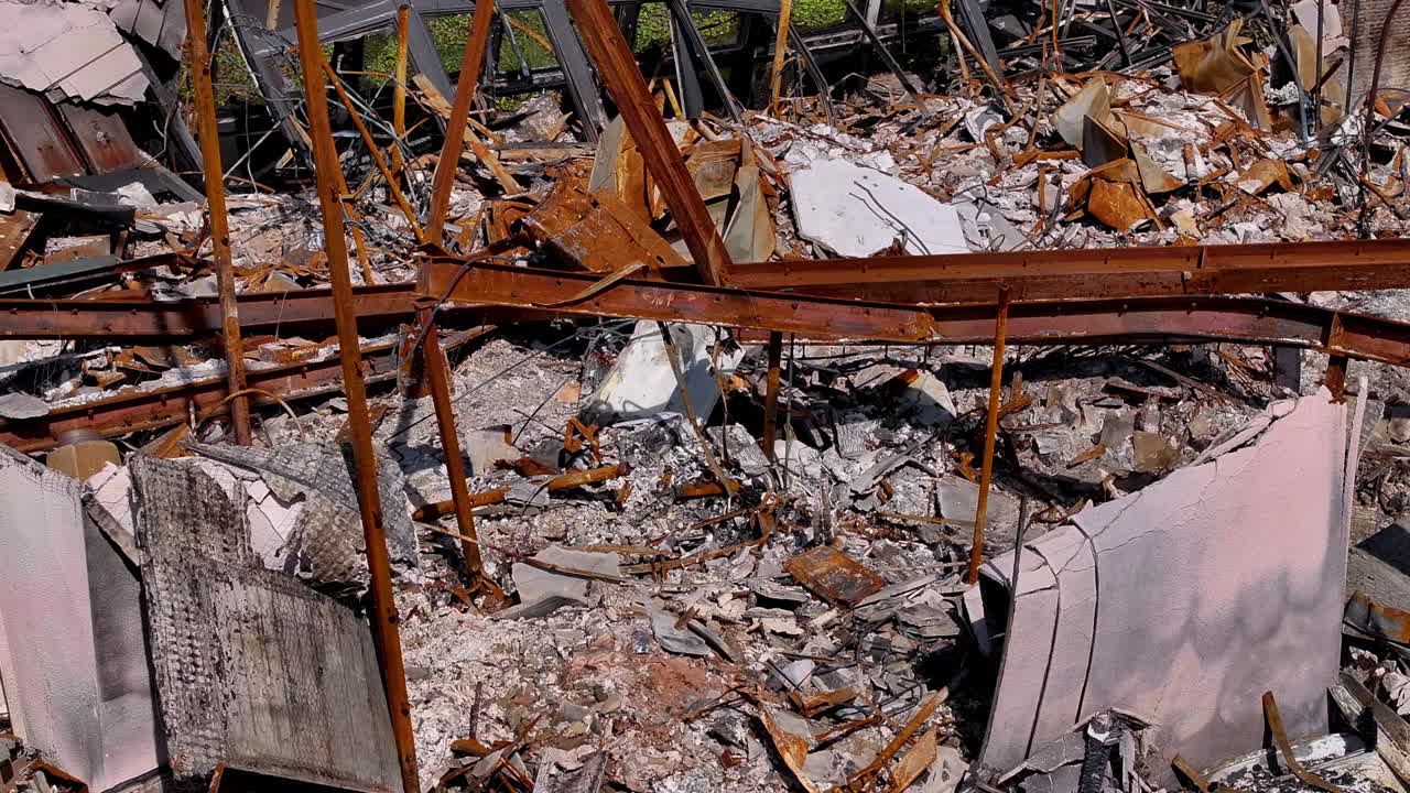 Aftermath of a destructive fire showing a ruined building with charred debris
