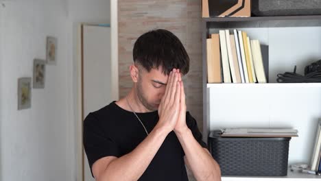 young man praying to higher entity and hoping for some form of intervention