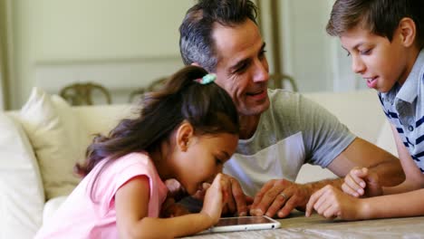 Vater-Und-Kinder-Nutzen-Digitales-Tablet-Im-Wohnzimmer