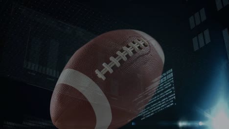 Animation-of-american-football-ball-over-data-processing-on-black-background