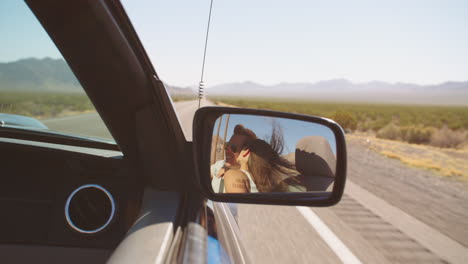 reflection of couple driving in convertible car shot on r3d