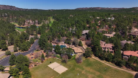 castle pines village golf course spring aerial drone colorado volleyball pickleball tennis courts club house front range morning gated community neighborhood homes cars roads backwards motion