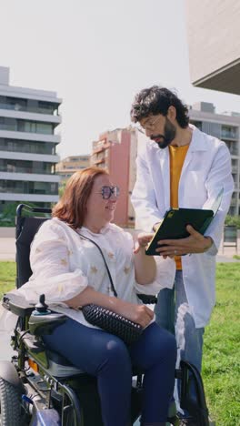 medical consultation with a woman in a wheelchair outdoors