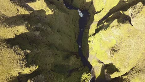 an aerial shot of a gorge from above in iceland