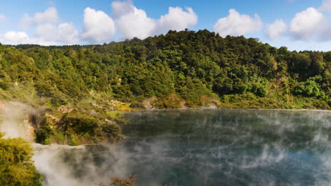 wide shot of frying pan lake with toxic sulfur steam during sunny day in new zealand