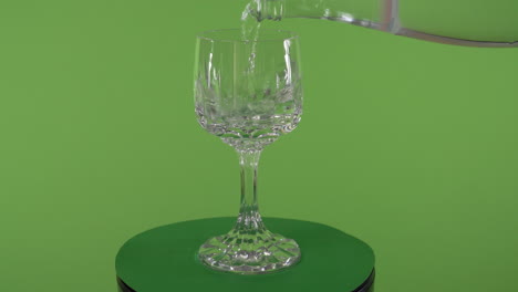 Agua-Del-Grifo-Limpia-Que-Se-Vierte-En-Un-Elegante-Vaso-Giratorio-Frente-A-La-Pantalla-Verde-Cromática