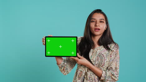 energetic salesman doing influencer marketing using green screen tablet