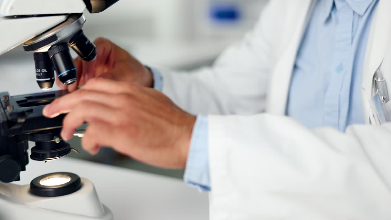 A focused scientist looking at a DNA sample under