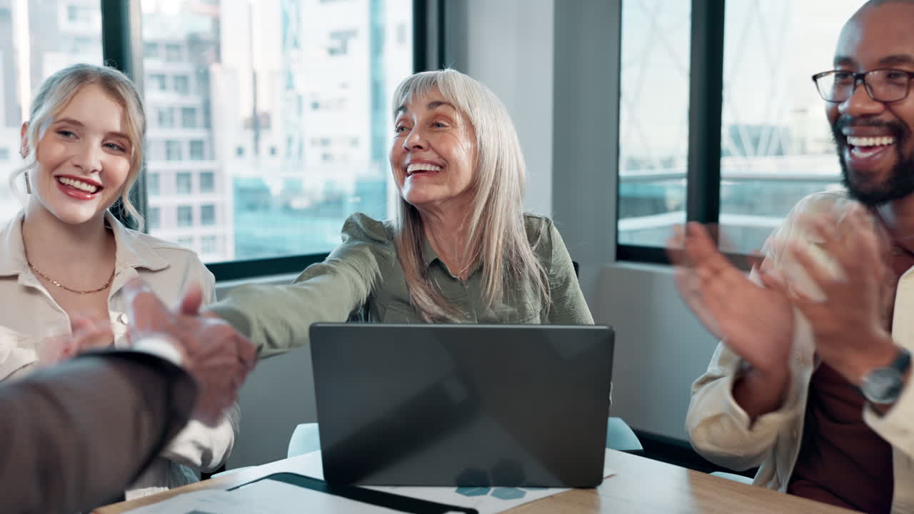 Diverse Team Celebrates Successful Deal with Handshake