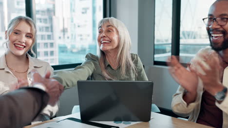 diverse team celebrates successful deal with handshake