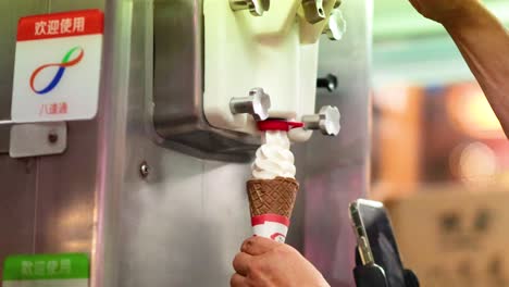 ice cream cone being filled from a machine