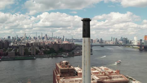 360 aerial of an industrial smokestack in brooklyn new york, city skyline, 4k