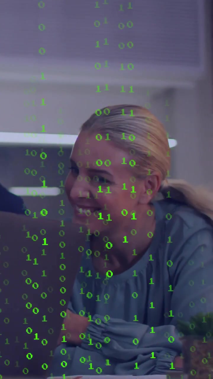 Vertical video: Woman leaning into laptop after man's cue, viewing tech chart with binary overlay