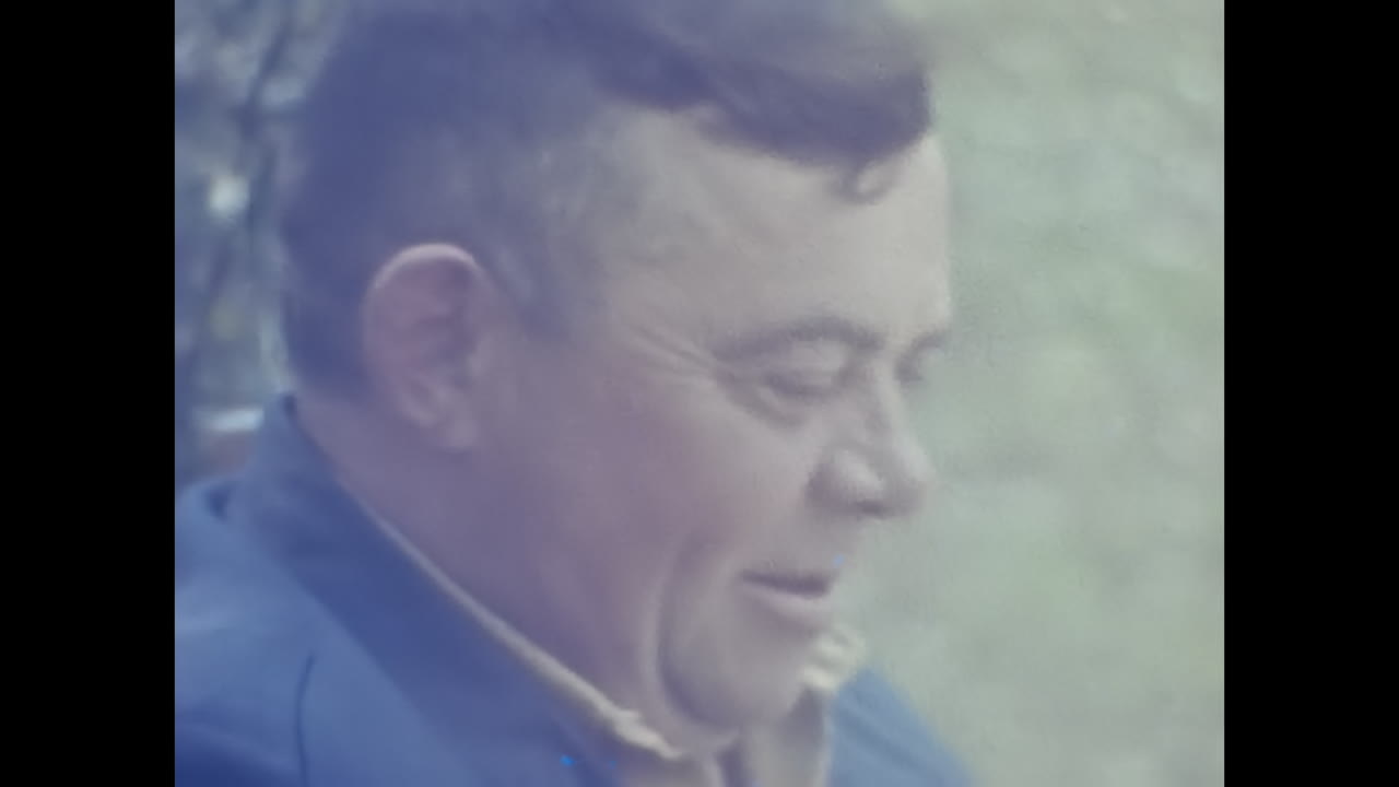 Woman in Red Jacket and White Headscarf Portraits Soviet-style Fashion. CIRCA USSR 1980s: A portrait of a woman wearing a red jacket and a white headscarf reminiscent of Soviet fashion.