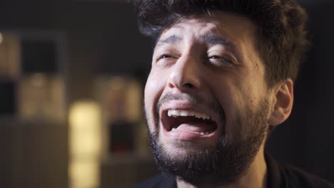 mentally ill man going crazy at home, crying.