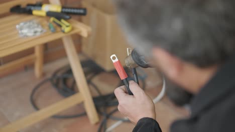 an electrician installing an inverter in a home. the image shows technical skill, modern tools, and attention to safety in electrical work