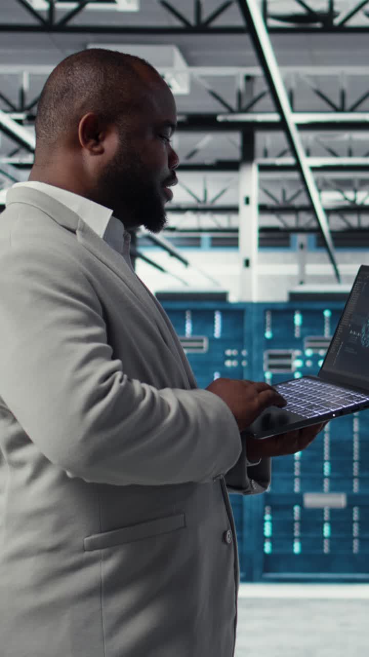 Vertical video Data center admin doing IT maintenance tasks using AI technology