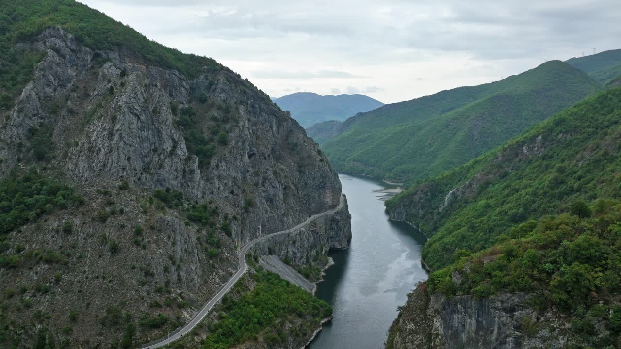 Aerial flythrough above the winding Shala River gorge with forested cliffs and vibrant water