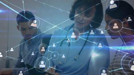 animation of network of connections with icons over caucasian female nurse talking with patients