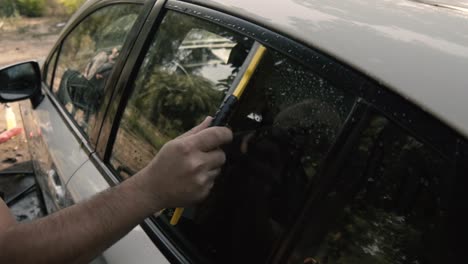 Close-up-of-a-male-wiping---drying-a-white-car