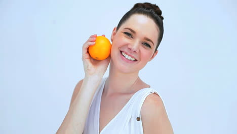 beautiful woman holding an orange