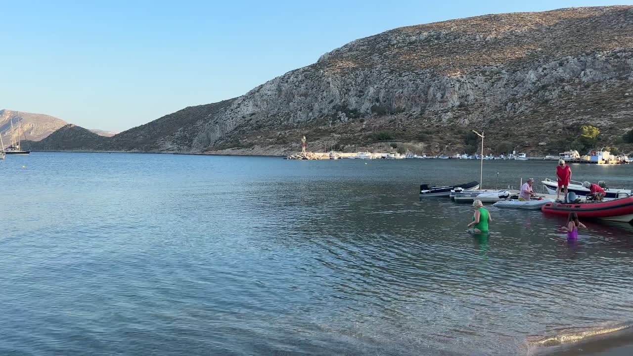Peaceful Mediterranean Sea: Sailboats, Family, and Scenic Views
