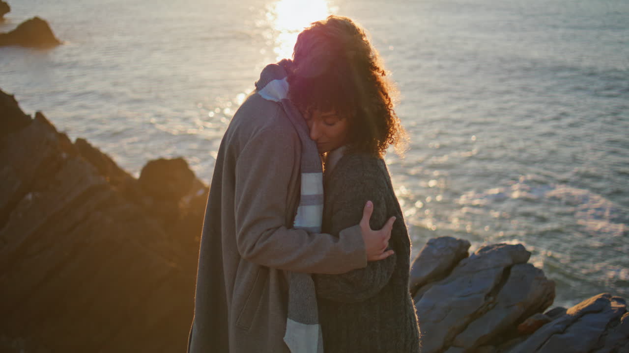 Romantic lovers hugging evening seashore closeup. Gentle man embracing woman