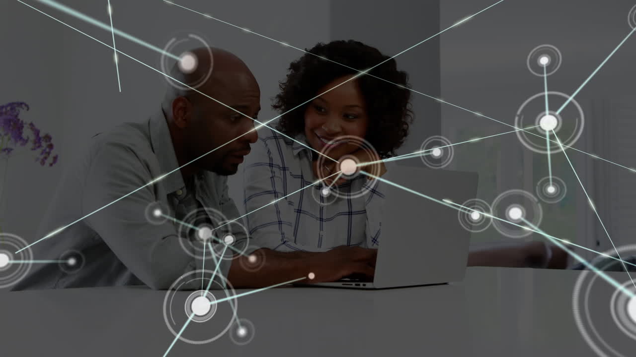 Animation of network of connections over happy african american female and male workers in office