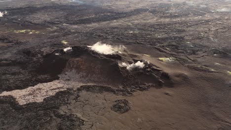 smoking igneous volcanic rock hill in desolate slag wasteland, iceland