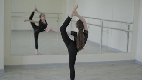 young ballerina practicing dance moves in studio