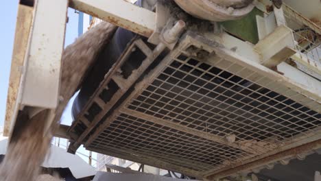 Low-angle-close-up-of-concrete-going-into-the-mixer-car