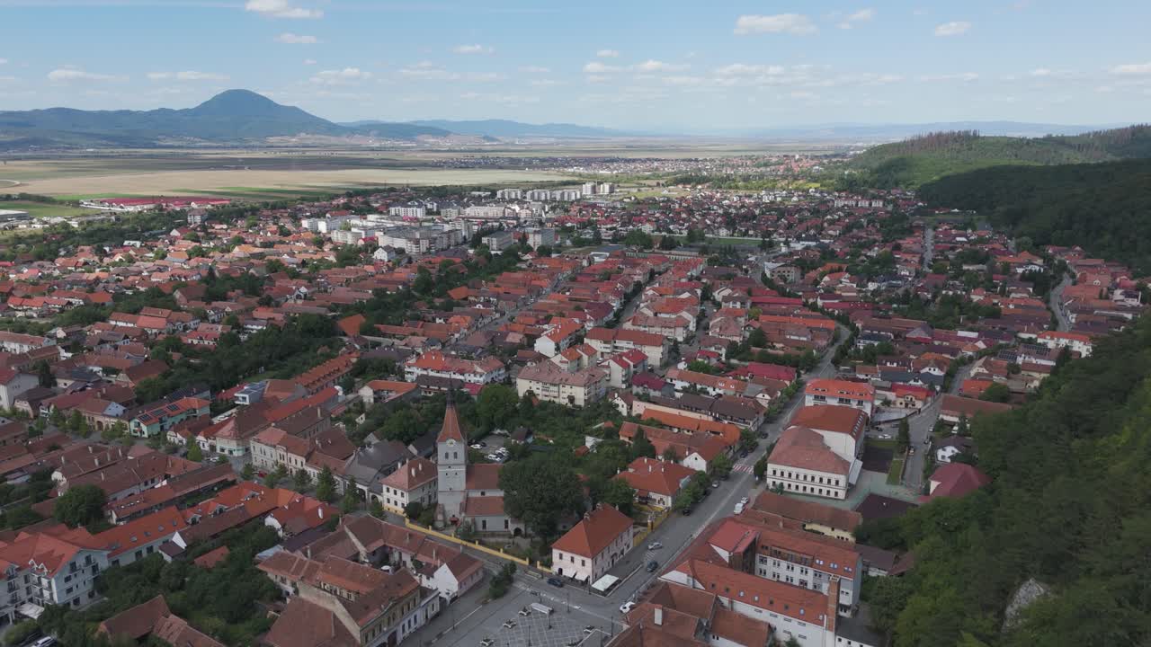 Aerial view of Râșnov, Romania, capturing the old town, rooftops, and surrounding landscape