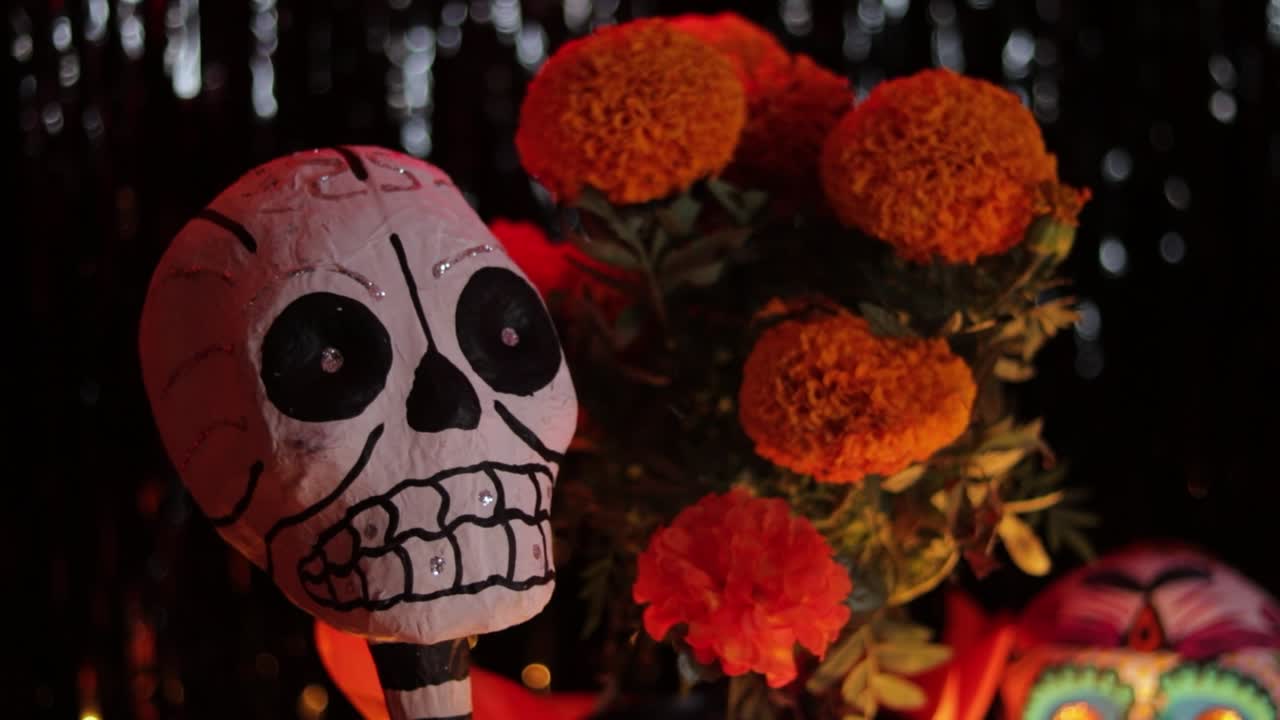 Skeleton decoration and cempasuchil blossoms on Dia de Muertos altar