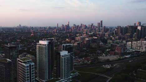 Aerial-view-over-the-Niagara-district,-toward-the-central-Toronto-skyline,-sunrise-in-Canada