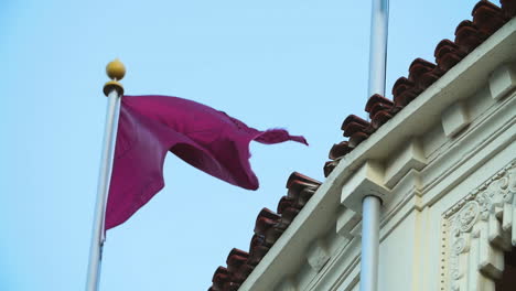 maroon red flag waves in the wind. off the coast of catalina island in california