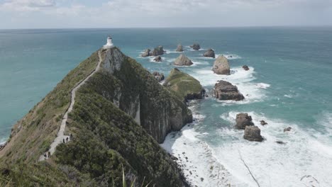 view of nugget point lighthouse in new zealand on a sunny day