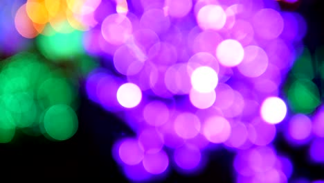 christmas tree with purple lights glowing. defocused bokeh lights.