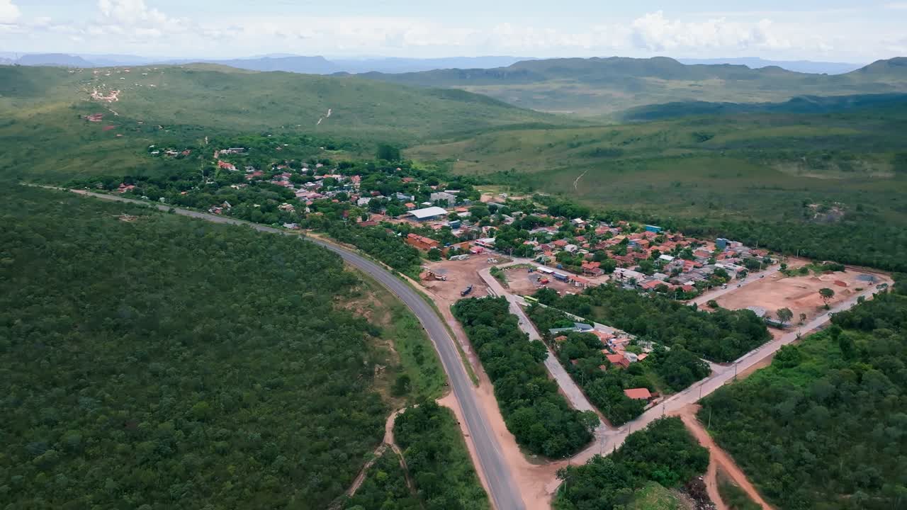 Aerial view capturing Vila de Sao Jorge in Alto Paraiso de Goias, showcasing its houses, roads, and lush vegetation within Chapada dos Veadeiros National Park in Brazil