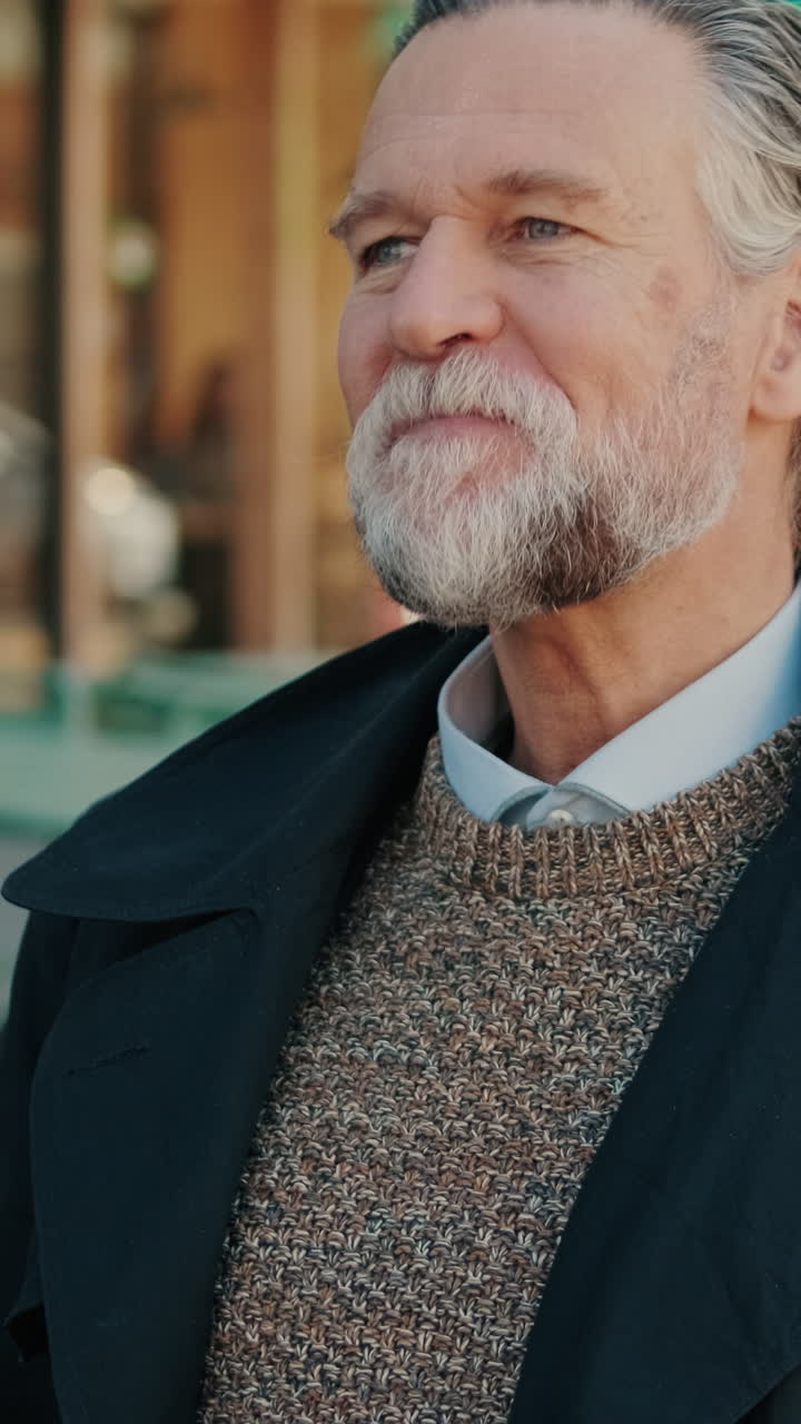 Mature Man Enjoys Orange Juice at Outdoor Cafe