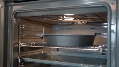 putting a baking dish into an oven