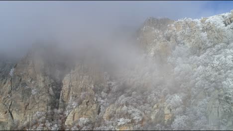 snowy mountain peaks in fog