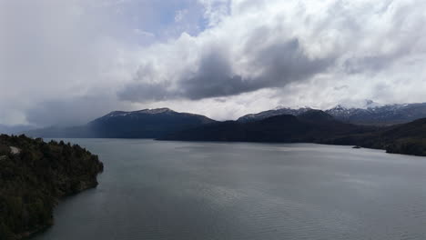 aerial view of lácar lake surrounded by mountains and dramatic sky in san martín de los andes neuquén, patagonia argentina