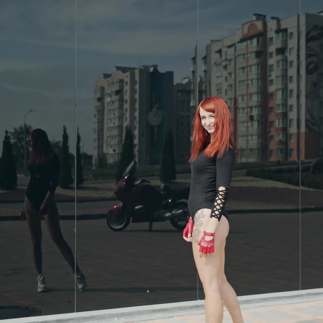 . Beautiful motorcyclist woman. Back view of young motorcyclist woman