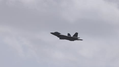f-22 raptor performs aerial maneuvers against a cloudy sky at avalon airshow in geelong, showcasing its stealth and agility